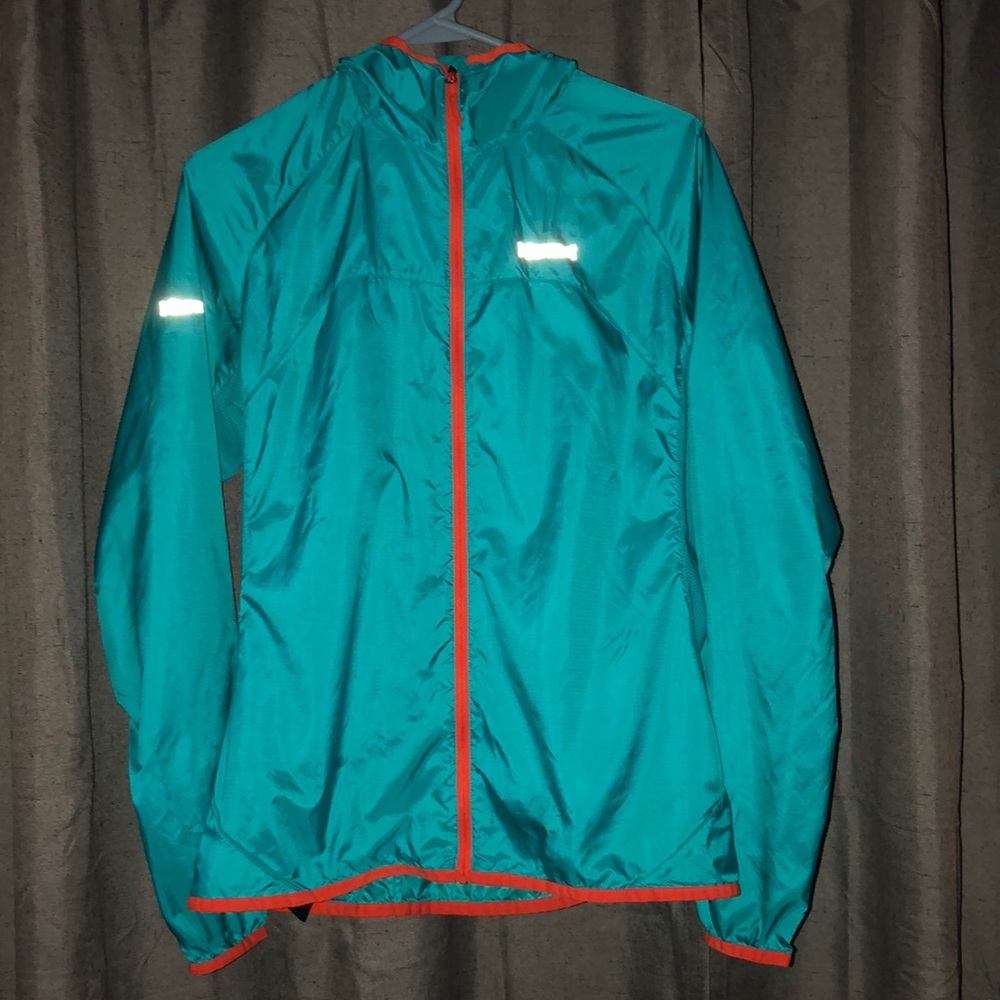 Marmot lightweight windbreaker. Turquoise blue with orange  trim. Size Medium.
